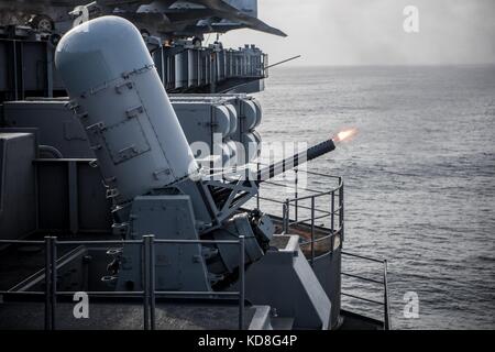 The aircraft carrier USS Theodore Roosevelt (CVN 71) fires its Phalanx close-in weapons system Stock Photo