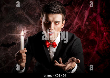 handsome man dressed in a Dracula costume for Halloween.  Stock Photo