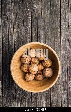 Tasty dried walnuts in bowl. Top view. Stock Photo