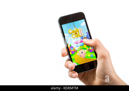 A child playing Candy Crush app on a mobile phone Stock Photo