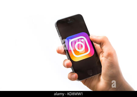 A boy using Instagram App on a mobile phone Stock Photo
