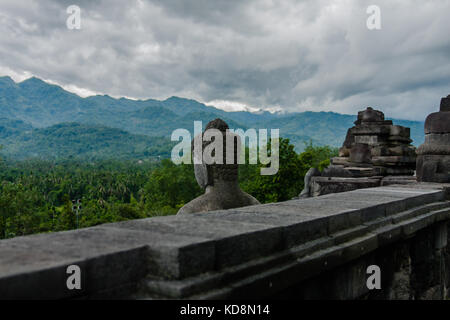 Buddhas of the Borobudur Temple watching surroundings, Yogyakarta, Indonesia Stock Photo