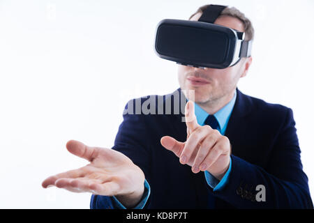 Attractive nice man looking at the virtual device Stock Photo