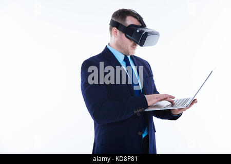Smart positive man using a laptop Stock Photo