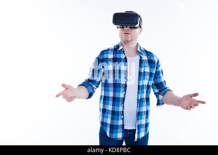 Nice good looking man using virtual reality glasses Stock Photo