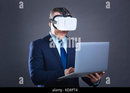 Nice delighted businessman using a laptop Stock Photo