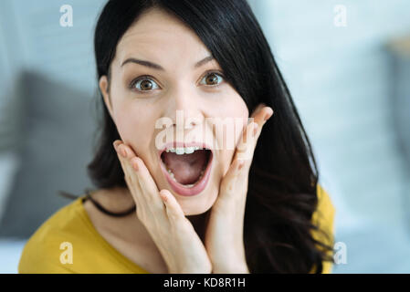 Surprised girl keeping her mouth wide opened Stock Photo