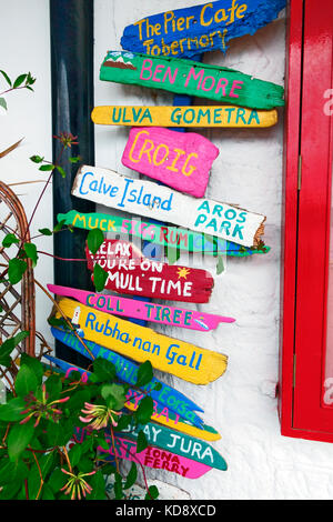 Colourful driftwood signs outside the Calmac ferry ticket office in Tobermory, Isle of Mull, Scotland Stock Photo