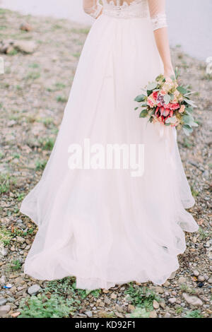 The lovely wedding bouquet at the back of the bride. Stock Photo