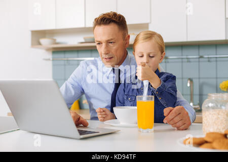 Pleasant nice man using a laptop Stock Photo