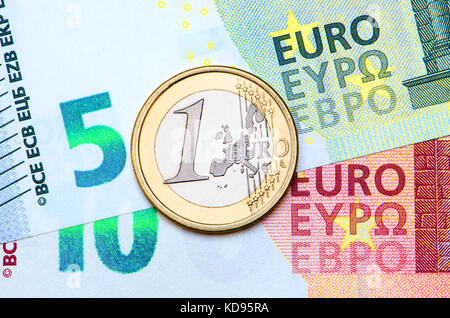 1 Euro coin on 5 and 10 Euro note Stock Photo