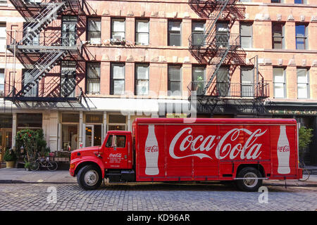 American Coca Cola delivery truck in front of Typical New york brick building with fire escapes, Manhattan, United states. Stock Photo