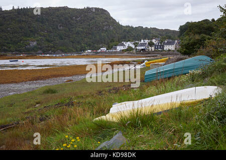 Across Loch Carron to Plockton. Low tide showing upturned and beached dinghies.  Plockton, Ross and Cromarty, Plockton Stock Photo