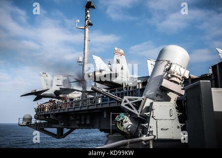 Phalanx Close-In Weapons System fires during a live-fire exercise aboard the aircraft carrier Stock Photo