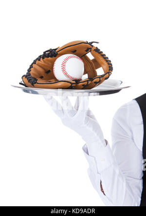 Close-up Of A Waiter Carrying Baseball And Catcher's Mitt In Tray Stock Photo