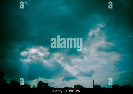 mystical cloudy sky over the city silhouette Stock Photo