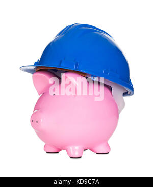 Piggybank wearing construction helmet. Isolated on white Stock Photo