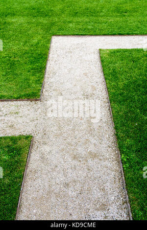 Geometric footpath in the lawn of a public garden. Stock Photo