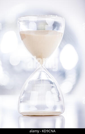 Close View Of Sand Flowing Through An Hourglass Stock Photo