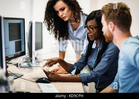 Software engineers working on project and programming in company Stock Photo
