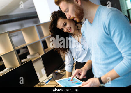 Portrait of software engineers using digital tablet Stock Photo