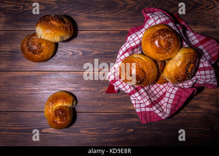 Traditional cretan brioches on wooden table. Stock Photo