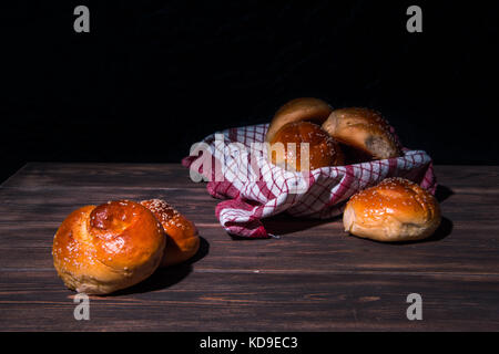 Traditional cretan brioches on wooden table. Stock Photo