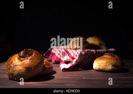 Traditional cretan brioches on wooden table. Stock Photo