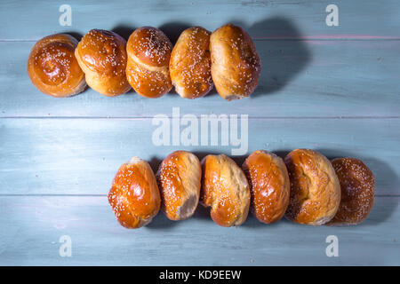 Traditional cretan brioches on wooden table. Stock Photo