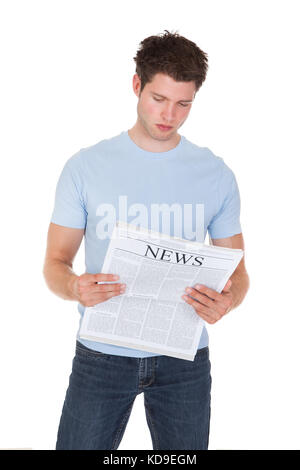 Young Man Reading Newspaper Isolated On White Background Stock Photo