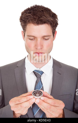 Close-up Of Young Businessman Looking At Compass Stock Photo