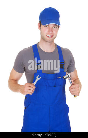 Male Mechanic Holding Ratchet And Spanner On White Background Stock Photo