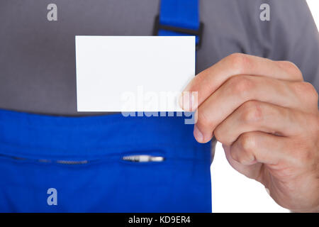 Portrait Of Happy Mechanic In Workwear Holding Visiting Card Stock Photo