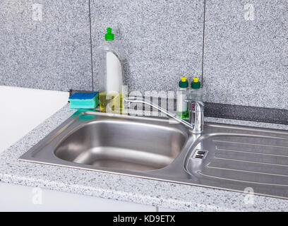 https://l450v.alamy.com/450v/kd9etx/dishwashing-liquid-with-sponge-on-silver-kitchen-sink-kd9etx.jpg