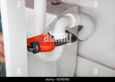 Close-up Of Wrench And Pipe In Kitchen Stock Photo