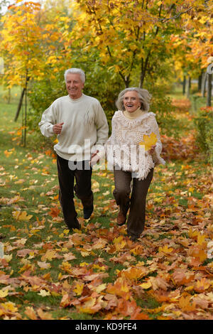 Senior couple running in park Stock Photo