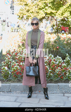 MILAN - SEPTEMBER 21: Woman with flowers decorated bag, Cartier