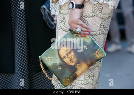 MILAN - SEPTEMBER 21: Woman with Louis Vuitton bag with Mona Lisa