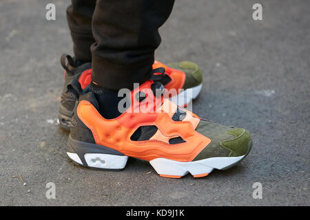 MILAN SEPTEMBER 21 Man with Reebok sport shoes in orange white