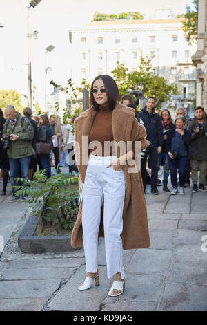 Yoyo Cao poses wearing Louis Vuitton dress and bag and St. Laurent