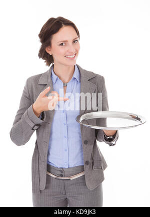 Smiling Businesswoman Holding Empty Plate On White Background Stock Photo