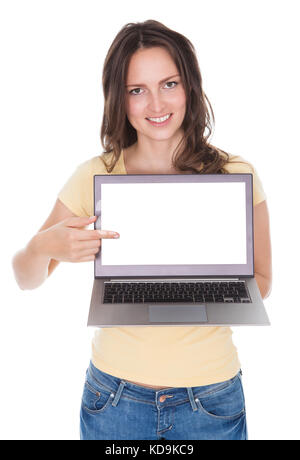 Portrait Of Smiling Woman Holding Laptop Over White Background Stock Photo