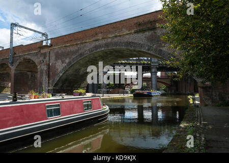 A narrowboat and Victorian railway bridges at Castlefield Basin on the Bridgewater Canal, Manchester, England, UK Stock Photo