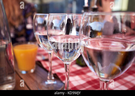 Row of pure drinking water glasses at summer terrace cafe. Stock Photo