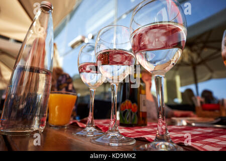 Row of pure drinking water glasses at summer terrace cafe. Stock Photo