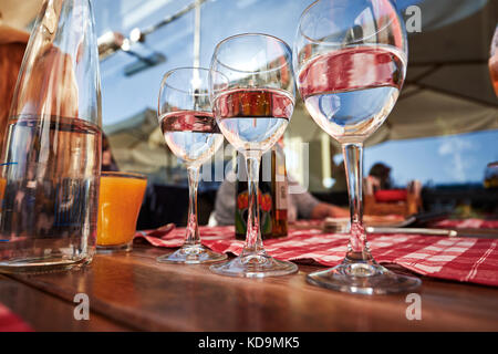 Row of pure drinking water glasses at summer terrace cafe. Stock Photo