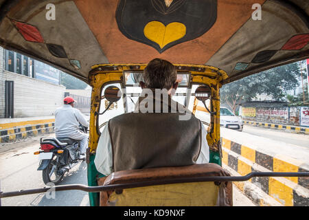 AGRA - INDIA  DECEMBER 6 2017. A rickshaw (also known as Tuc Tuc) driver is driving in the streets of Agra in India. Agra is a city on the banks of th Stock Photo