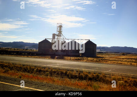 A small group of silos light up by the sunset. Stock Photo