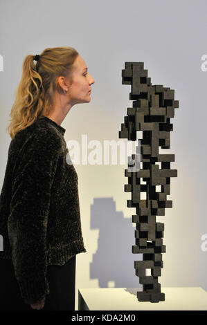 London, UK. 12th Oct, 2017. A staff member views 'Small Charge', 2015, by Antony Gormley (Est. GBP120-180k) at a preview of artworks for the 'Art for Grenfell' auction taking place at Sotheby's, New Bond Street, on 16 October. Leading contemporary artists have agreed to donate works to the auction, the proceeds of which will be divided equally amongst the 158 surviving families of the Grenfell Tower fire by the Rugby Portobello Trust charity. Credit: Stephen Chung/Alamy Live News Stock Photo