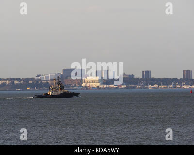Sheerness, Kent, UK. 12th Oct, 2017. UK Weather: a sunny end to a warm autumn day. Two tugs pass in front of Southend on sea. Credit: James Bell/Alamy Live News Stock Photo